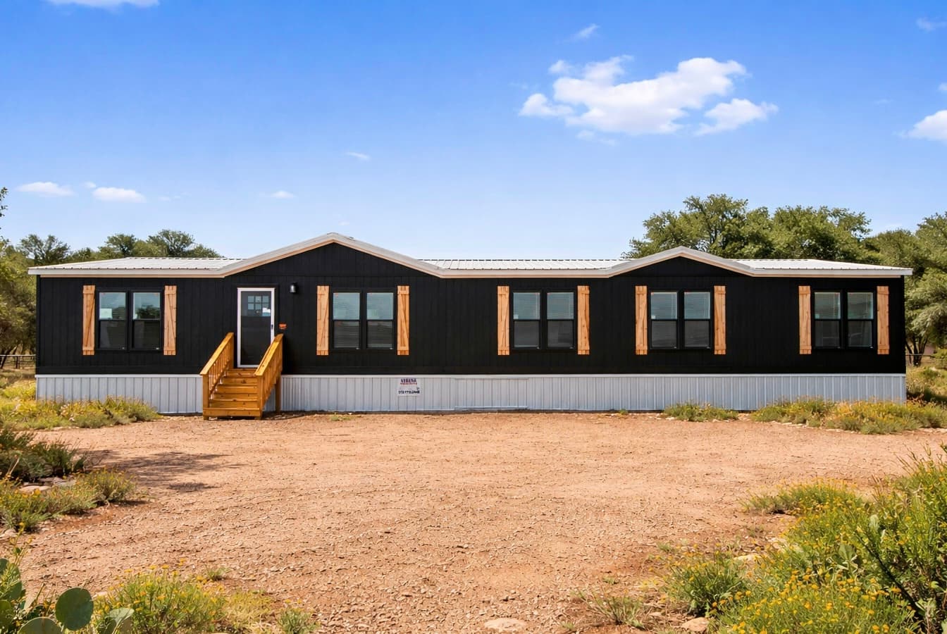 Texas Homes Direct The Mallard — black board-and-batten doublewide with cedar shutters on a Texas lot