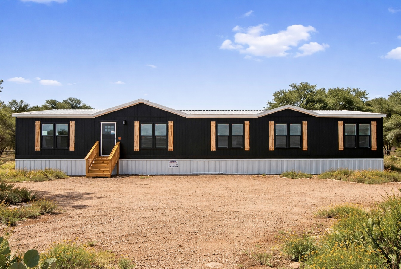 Texas Homes Direct The Mallard — black board-and-batten doublewide with cedar shutters on a Texas lot